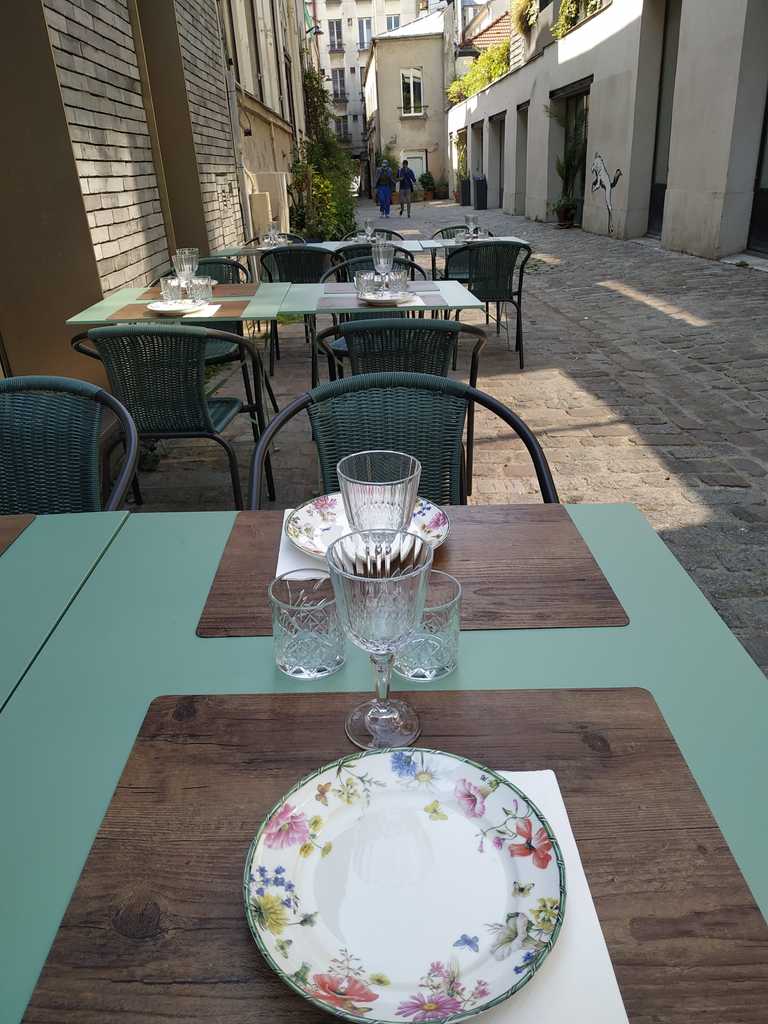 a table on the terrace of a restaurant with no customers 